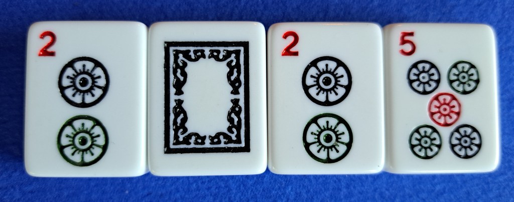 Block of single tiles with dots and soap or white dragon used as a zero to make 2025.