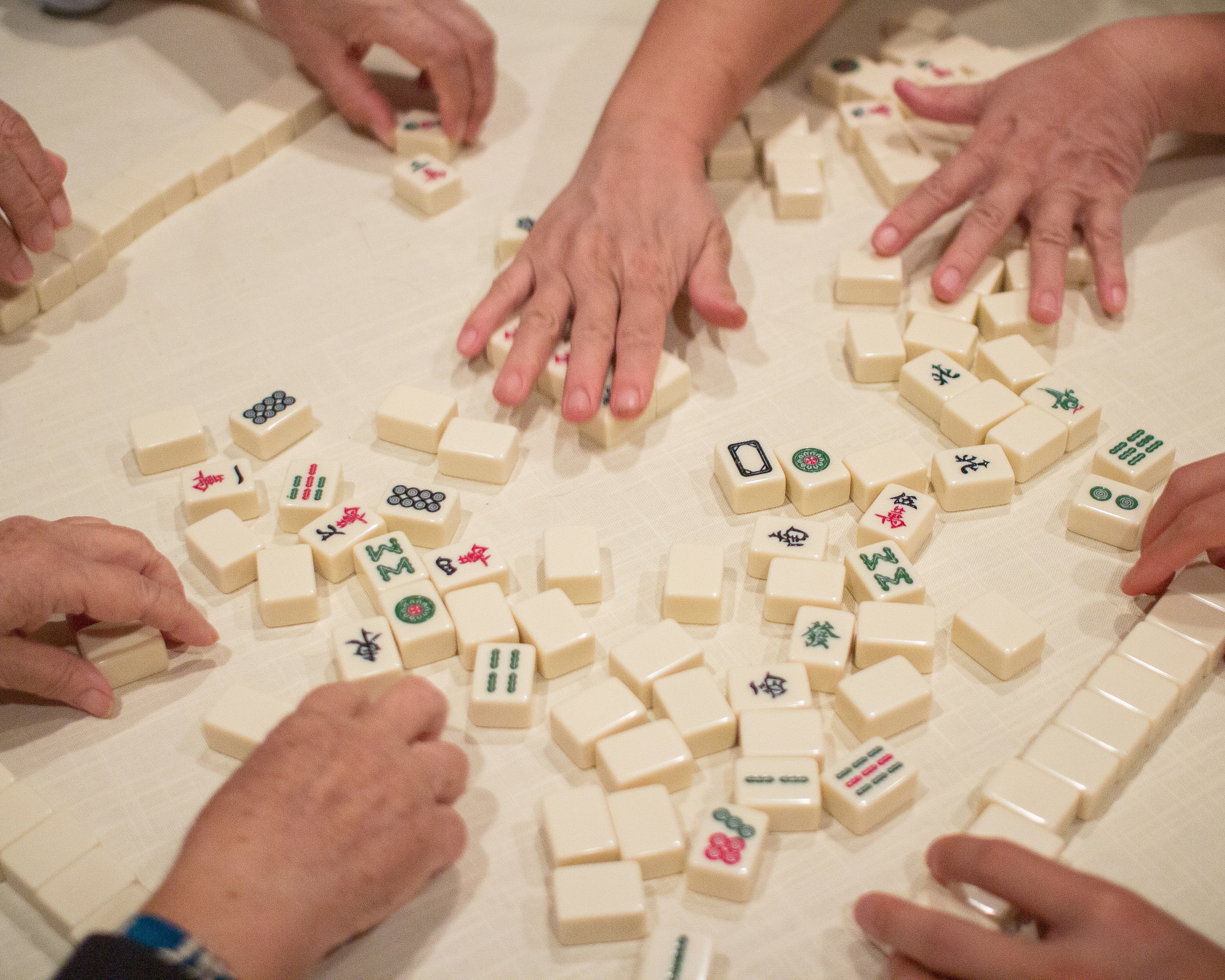 Hands on mahjong tiles
