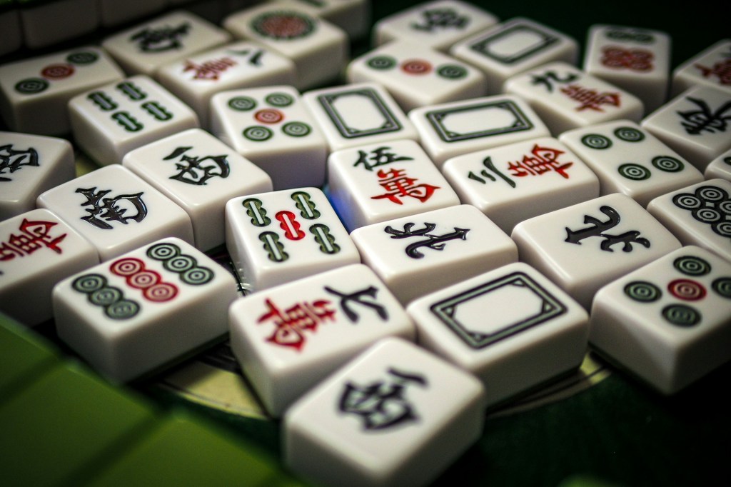 Assortment of mahjong tiles, including bams, craks, dots and dragons.