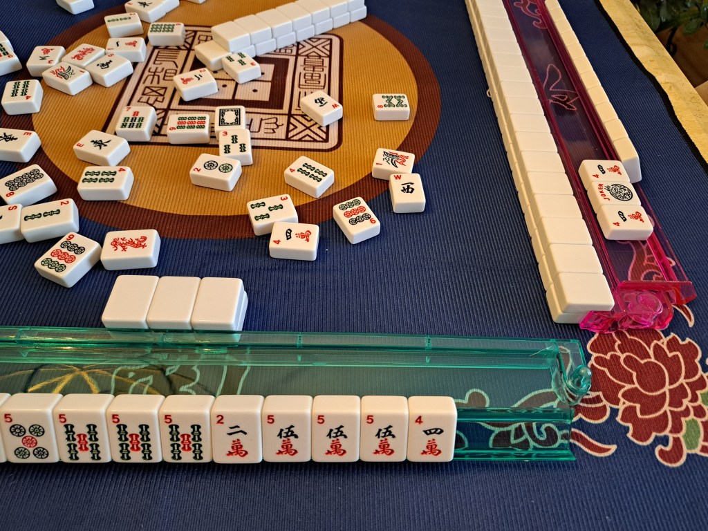 American Mahjong Joker Bait strategy: hold an extra pair, discard mid-game to trigger an exposure with a joker, then exchange your second tile for the joker.