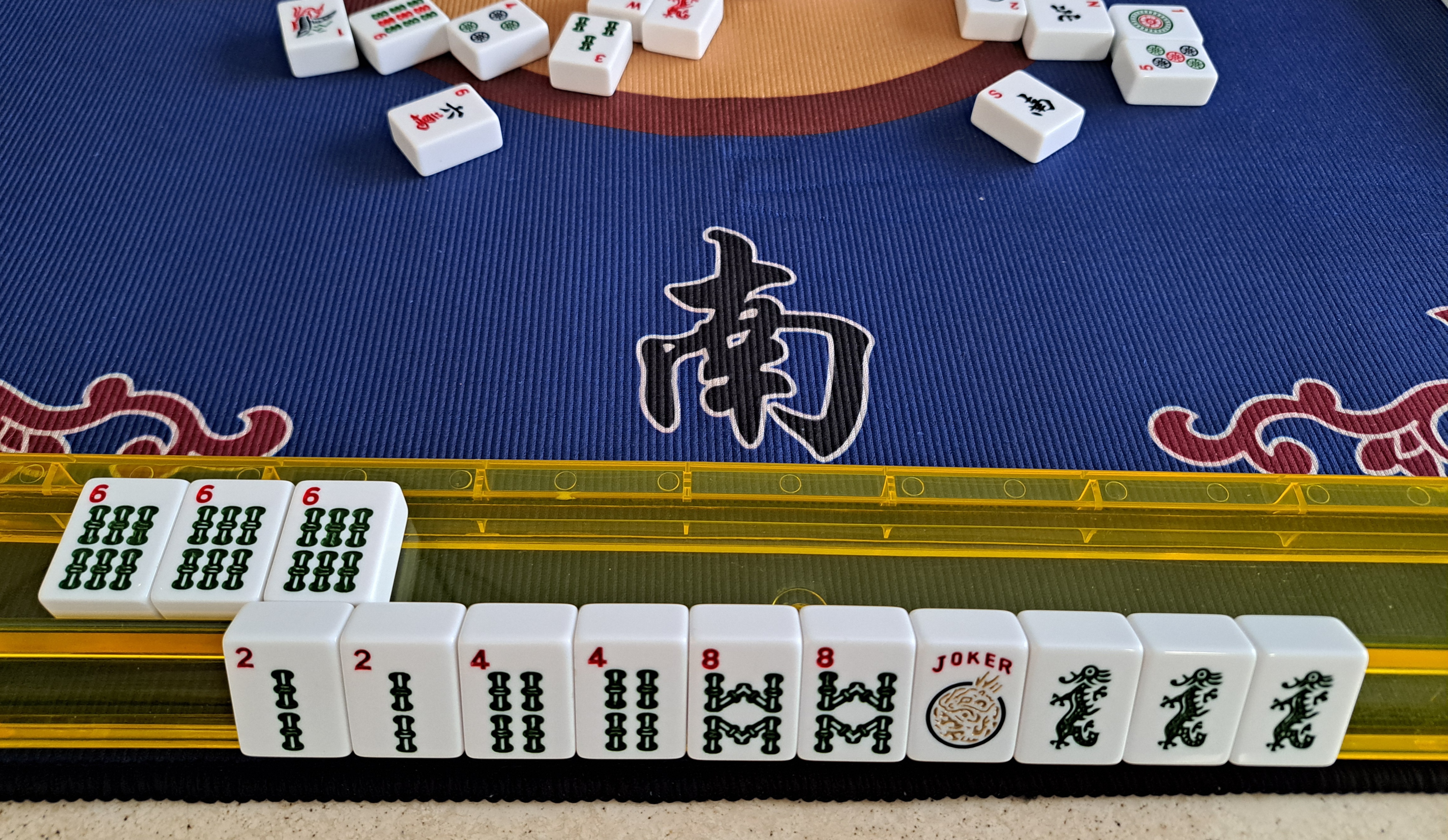 Six Bam tiles exposed after claiming a discard for hand that is composed of 2468 Bams and Green Dragons.