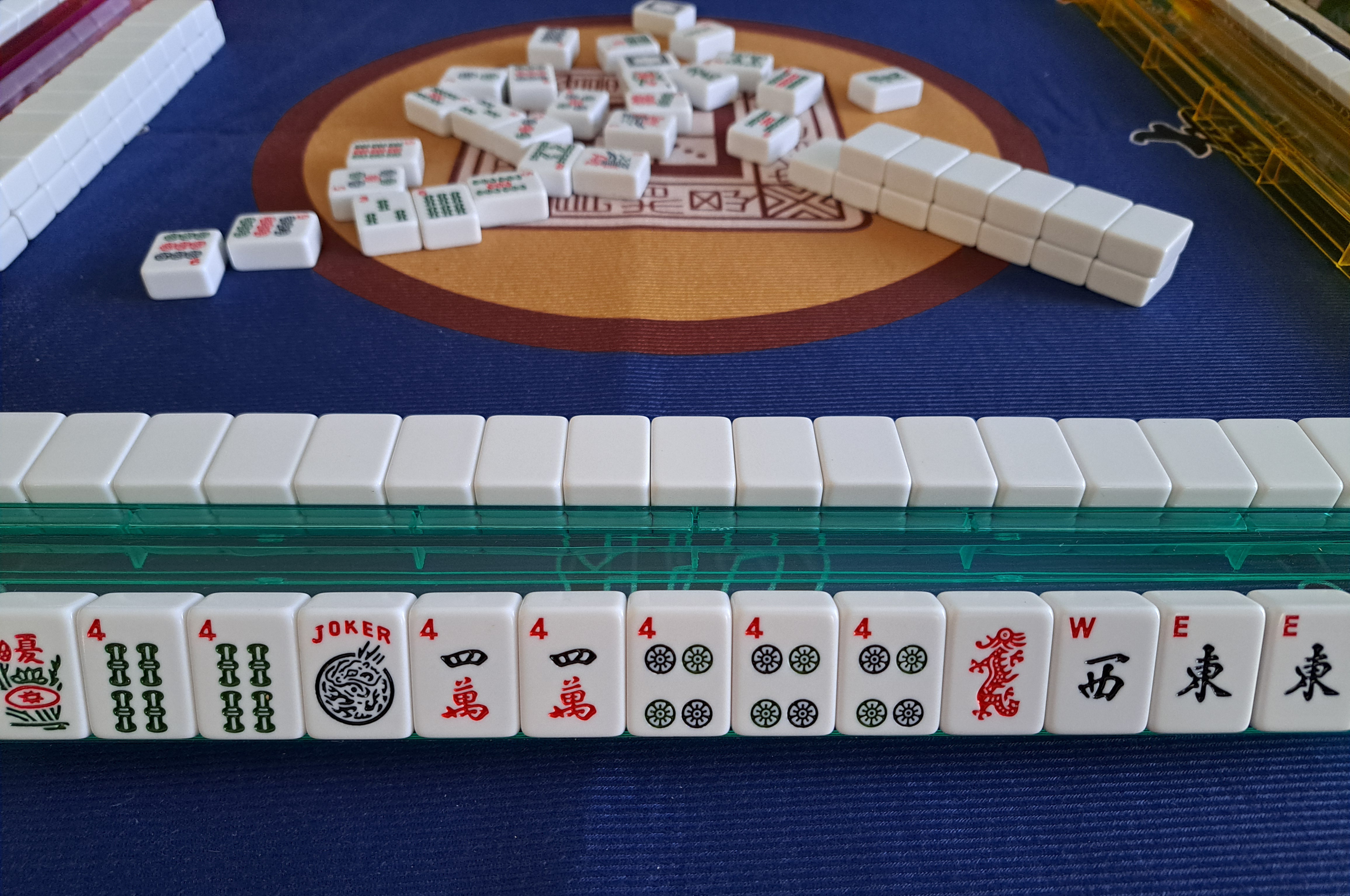 Mah Jongg hand switching from Any Like Number using fours to Winds and Dragons with East and West winds, showing overlap in tiles and strategy pivot.