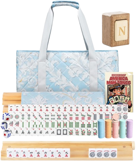 A neatly arranged set of a mahjong game including a blue quilted tote bag, several sets of tiles, dice, a rulebook titled 'America Mah-Jongg', and colorful scoring chips or markers.
